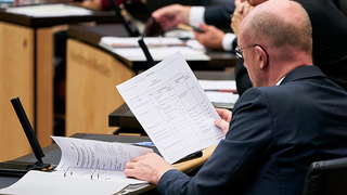 Foto: Betrachten von Unterlagen durch ein Bundesratsmitglied